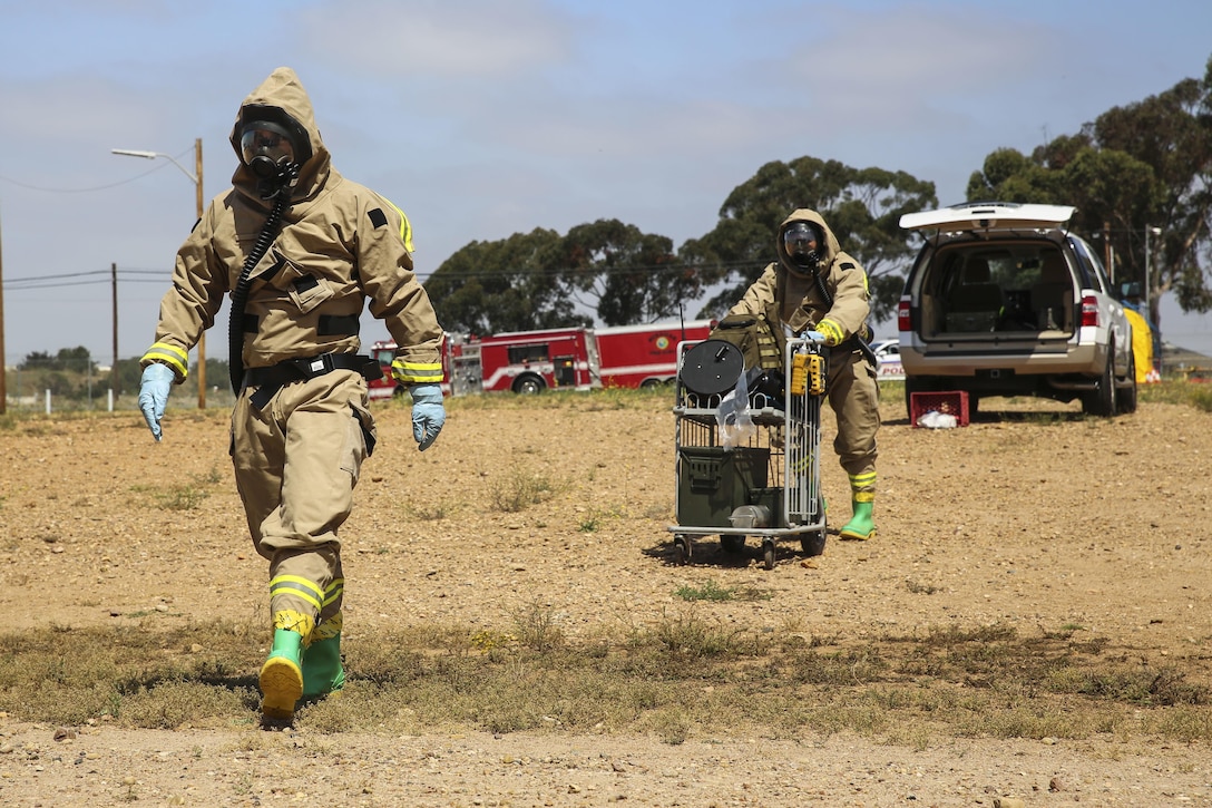 Marines with Explosive Ordnance Disposal walk toward the hazardous area during a Chemical, Biological, Radiological, Nuclear and High-Yield Explosives (CBRNE) exercise at the gas chamber aboard Marine Corps Air Station Miramar, Calif., May 18. The exercise revolved around PMO, the Miramar Fire Department, Explosive Ordnance Disposal, and Aircraft Rescue and Firefighting working together to identify and eliminate the threat of a simulated clandestine drug lab. (U.S. Marine Corps photo by Cpl. Alissa Schuning/Released)