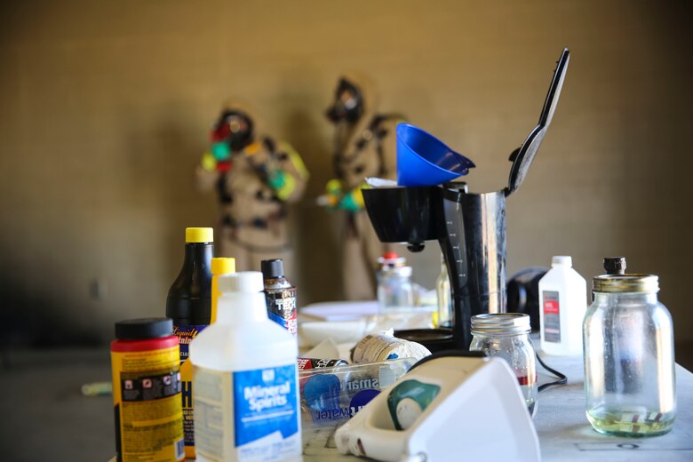 Marines with the Aircraft Rescue and Firefighting hazardous material team assess the contaminated area during a Chemical, Biological, Radiological, Nuclear and High-Yield Explosives (CBRNE) exercise at the gas chamber aboard Marine Corps Air Station Miramar, Calif., May 18. The exercise revolved around PMO, the Miramar Fire Department, Explosive Ordnance Disposal, and Aircraft Rescue and Firefighting working together to identify and eliminate the threat of a simulated clandestine drug lab. (U.S. Marine Corps photo by Cpl. Alissa Schuning/Released)