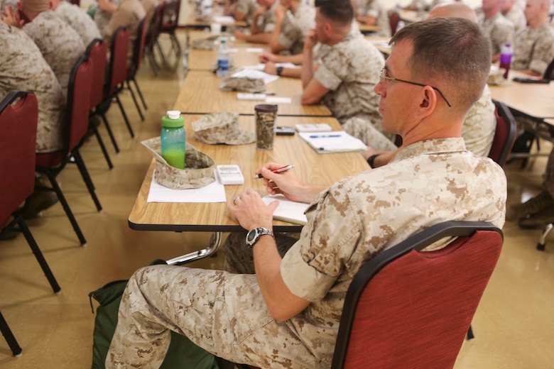 An officer takes notes during the U.S. Marine Corps Integration Education Plan class aboard Marine Corps Air Station Miramar, Calif., June 9. Maj. Misty Posey, plans officer for the Manpower Integration Branch, traveled to various Marine Corps bases to give classes, answer questions and clear misconceptions about females integrating into combat roles. (U.S. Marine Corps photo by Lance Cpl. Harley Robinson/Released)