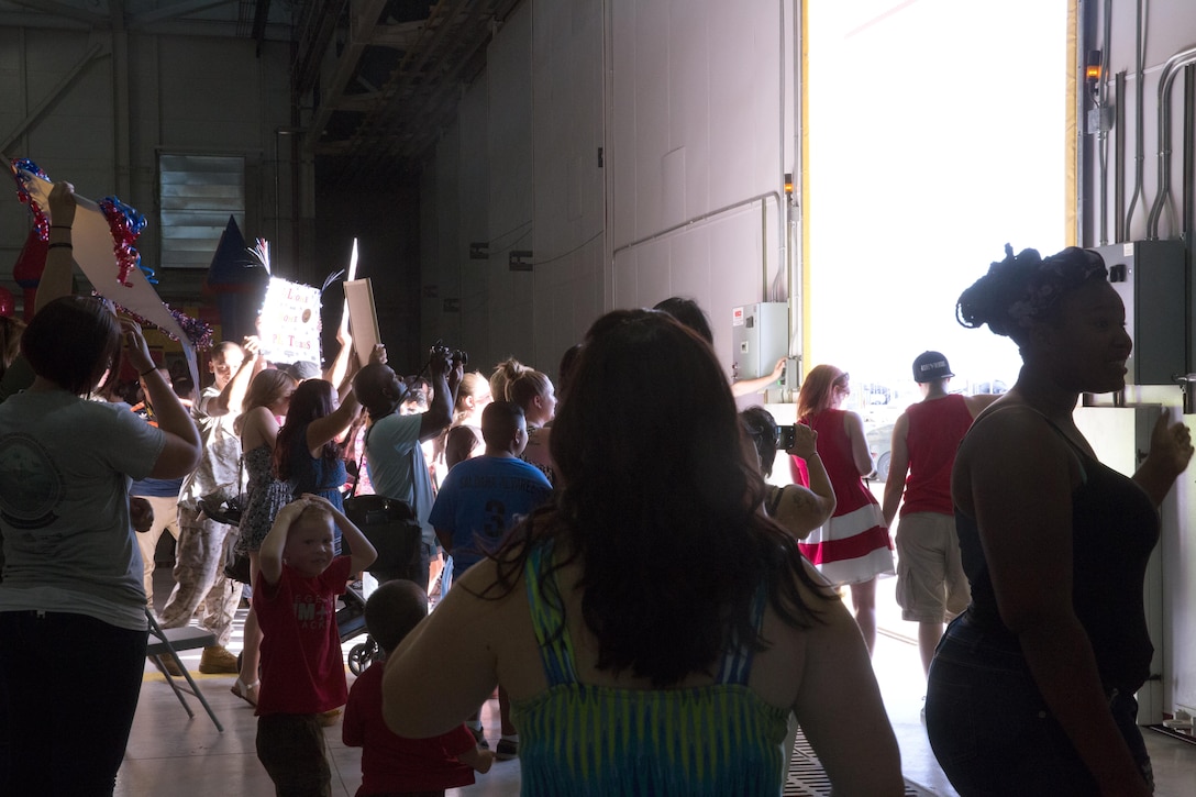 The hangar  doors of Marine Fighter Attack Squadron (VMA) 214 “Black Sheep” open to unite friends, family members and loved ones with returning the Marines and Sailors of VMA-214 and Marine Aviation Logistics Squadron 13 “Black Widows” aboard Marine Corps Air Station Yuma, Ariz., June 7. Approximately 100 Marines and Sailors returned from a seven-month deployment with the 31st Marine Expeditionary Unit and supported missions in the Pacific theater. (U.S. Marine Corps photo by Sgt. Lillian Stephens/Released)