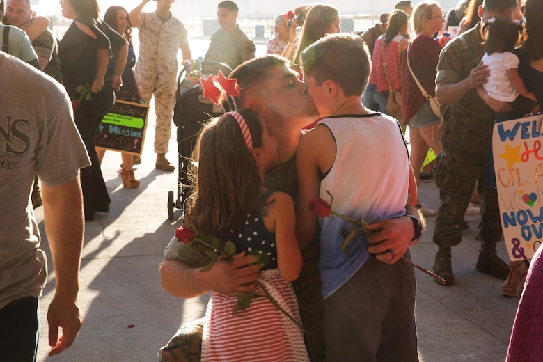 A Marine with Marine Attack Squadron (VMA) 214 “Black Sheep” reunites with his children aboard Marine Corps Air Station Yuma, Ariz., June 7. Approximately 100 Marines and Sailors returned from a seven-month deployment with the 31st Marine Expeditionary Unit and supported missions in the Pacific theater. (U.S. Marine Corps photo by Sgt. Lillian Stephens/Released)