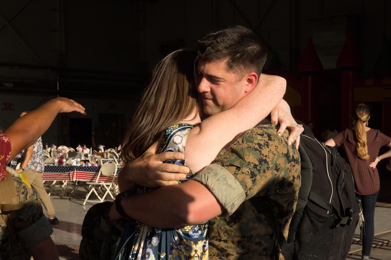 A Marine with Marine Attack Squadron (VMA) 214 “Black Sheep” embraces a loved one aboard Marine Corps Air Station Yuma, Ariz., June 7. Approximately 100 Marines and Sailors returned from a seven-month deployment with the 31st Marine Expeditionary Unit and supported missions in the Pacific theater. (U.S. Marine Corps photo by Sgt. Lillian Stephens/Released)