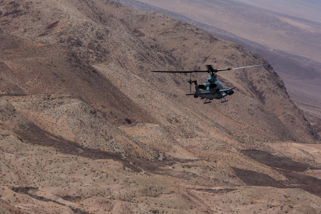 An AH-1Z Viper with Marine Light Attack Helicopter Squadron (HMLA) 267 “Stingers” maneuvers to assault a simulated target aboard Marine Corps Air Ground Combat Center Twentynine Palms, Calif., June 10. Marines with HMLA-267 supported Marines with 3rd Battalion, 7th Marine Regiment, during a close-air-support training mission aboard the combat center. (U.S. Marine Corps photo by Sgt. Lillian Stephens/Released) (U.S. Marine Corps photo by Sgt. Lillian Stephens/Released)