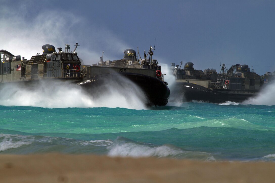 Landing craft air cushion conduct an amphibious assault during the MARFORPAC-hosted U.S. Pacific Command Amphibious Leaders Symposium (PALS) at Marine Corps Training Area Bellows May 19, 2015. PALS is designed to bring together senior leaders of allied and partner Marine Corps, naval infantries, and militaries spanning the Indo-Asia-Pacific region with interest in military amphibious capability development. This year, 22 nations sent representatives to observe the training.