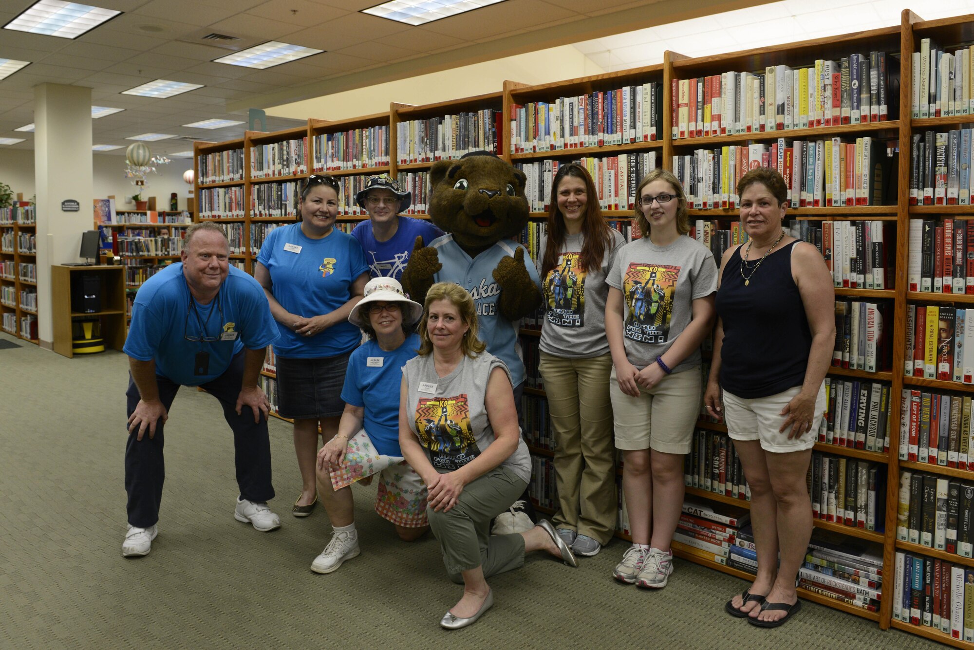 Joint Base Elmendorf-Richardson Library staff gather with Kodi from the Alaska Aces at the JBER Library, June 16, 2016. The program’s theme this year is sports and will give the JBER community the opportunity to collect prizes for time spent reading. (U.S. Air Force photo by Airman 1st Class Valerie Monroy)
