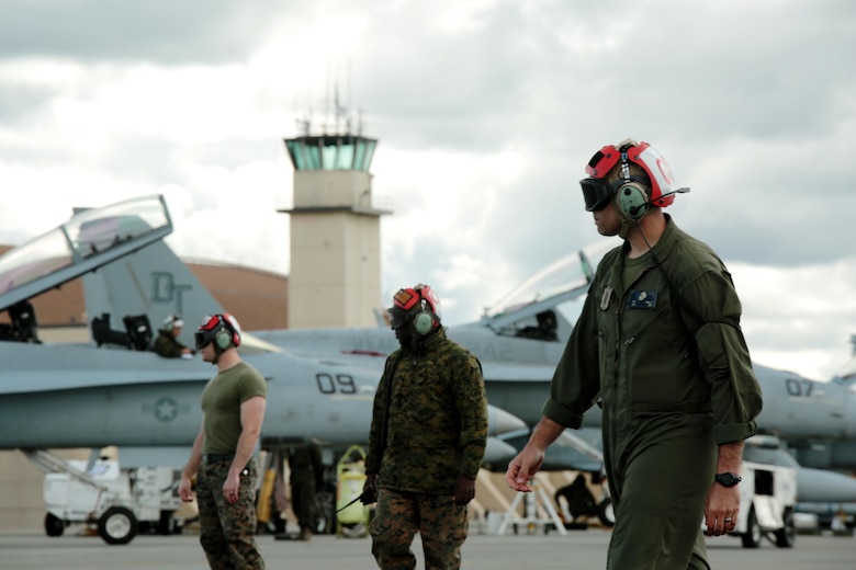 U.S. Marine Corps Sgt. Malcolm Cappelle, a quality assurance safety observer with Marine Fighter Attack Squadron (VMFA) 314, stationed at Marine Corps Air Station Miramar, California, and forward deployed to MCAS Iwakuni, Japan, walks with his team to an arriving F/A-18C Hornet during exercise Red Flag-Alaska 16-2 at Eielson Air Force Base, Alaska, June 16, 2016. Cappelle’s team carried and secured ordnance on the squadron’s fighter jets in support of exercise Red Flag-Alaska 16-2. (U.S. Marine Corps photo by Lance Cpl. Donato Maffin/Released)
