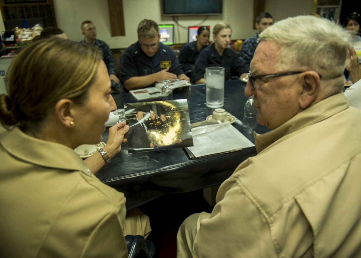 160617-N-IK388-012 SAN DIEGO (June 17, 2016) " Cmdr. Amy McInnis, left, commanding officer of guided-missile destroyer USS Howard (DDG 83), and Dan Mulvihill, a Vietnam War Battle of Hill 488 survivor, shared a photo of 1st Sgt. Jimmie E. Howard, the ship™s namesake and a Medal of Honor recipient during a ship tour. Howard hosted the tour to recognize the 50th anniversary of the June 15, 1966 battle. (U.S. Navy photo by Mass Communication Specialist 2nd Class Stacy M. Atkins Ricks/Released)