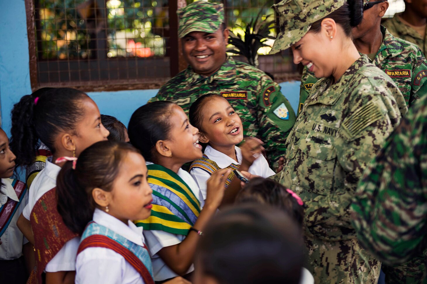 A group of students at Aimutin School speak with Petty Officer 3rd Class Margaret Villegas before a ribbon cutting marking the completion of the renovation of the school for Pacific Partnership 2016 in Dili, Timor Leste, June 20, 2016. Timorese Soldiers, U.S. Navy Seabees, U.S. Marines and Australian engineers have been working together to renovate the school's courtyard and facade. This year marks the sixth time the mission visited Timor Leste since its first visit in 2006. Medical, engineering and various other personnel embarked aboard Mercy are working side-by-side with partner nation counterparts, exchanging ideas, building best practices and relationships to ensure preparedness should disaster strike. U.S. Navy photo by Petty Officer Class Hank Gettys