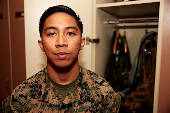 U.S. Marine Corps Cpl. Harley Damarputra, an aviation life-support equipment technician and collateral duty inspector with Marine Fighter Attack Squadron (VMFA) 314, stationed at Marine Corps Air Station Miramar, California, forward deployed to MCAS Iwakuni, Japan, poses for a photo in front of a pilot’s life support equipment during exercise Red Flag-Alaska 16-2 at Eielson Air Force Base, Alaska, June 16, 2016. Damarputra supports the squadron as a life-support equipment technician and collateral duty inspector by ensuring the pilots’ safety gear is working properly. (U.S. Marine Corps photo Lance Cpl. Donato Maffin/Released) 