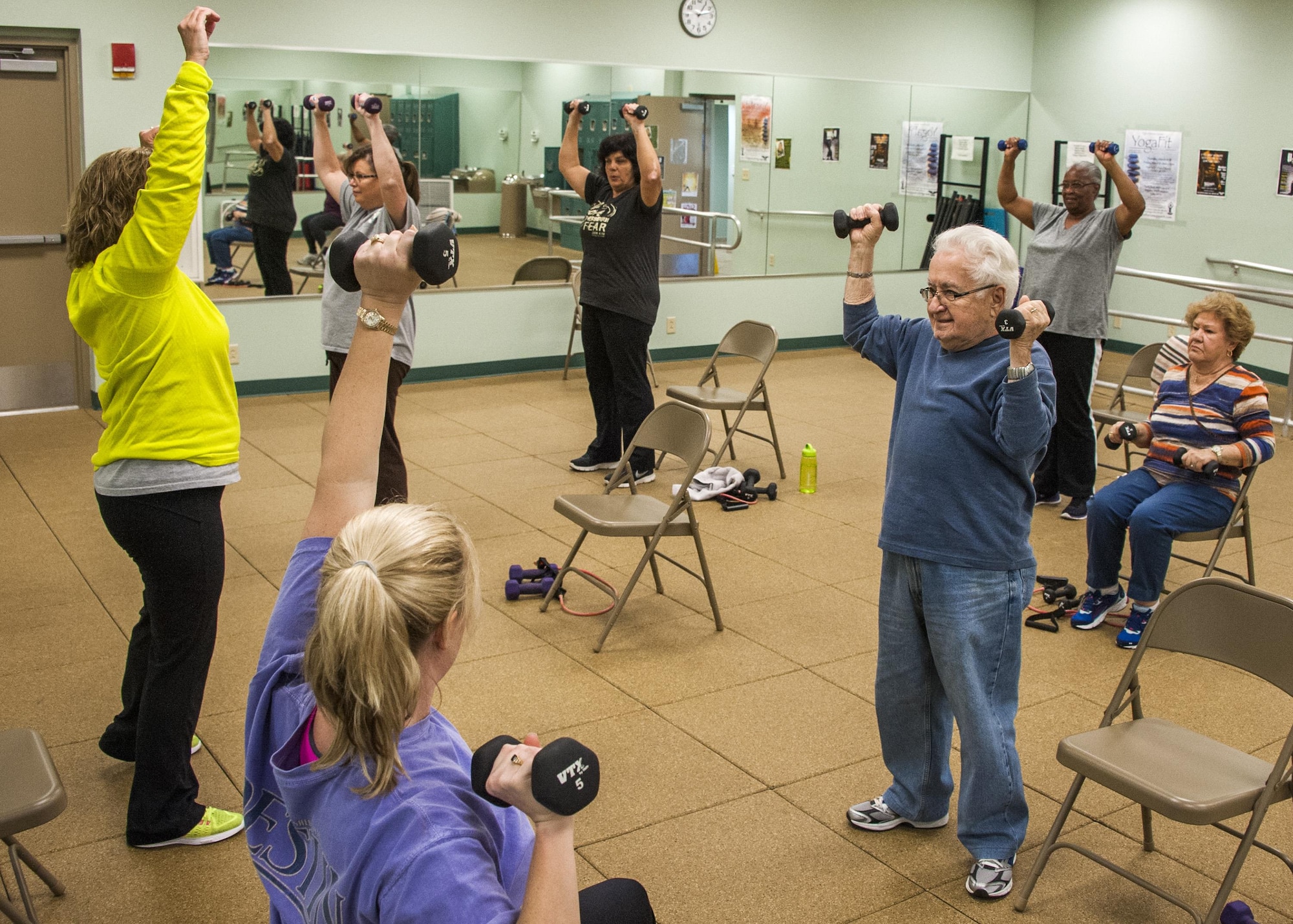 Nicole Sisk, 96th Medical Group clinical health promotion coordinator, helps Frank Acosta with his tricep extension during an exercise session Feb. 4 in Building 720 at Eglin Air Force Base, Fla. Go4Life is an eight-week program that builds strength, balance and flexibility. The program also encourages sedentary, older adults to make health improvements by making physical activity a part of their daily routine. (U.S. Air Force photo/Ilka Cole)
