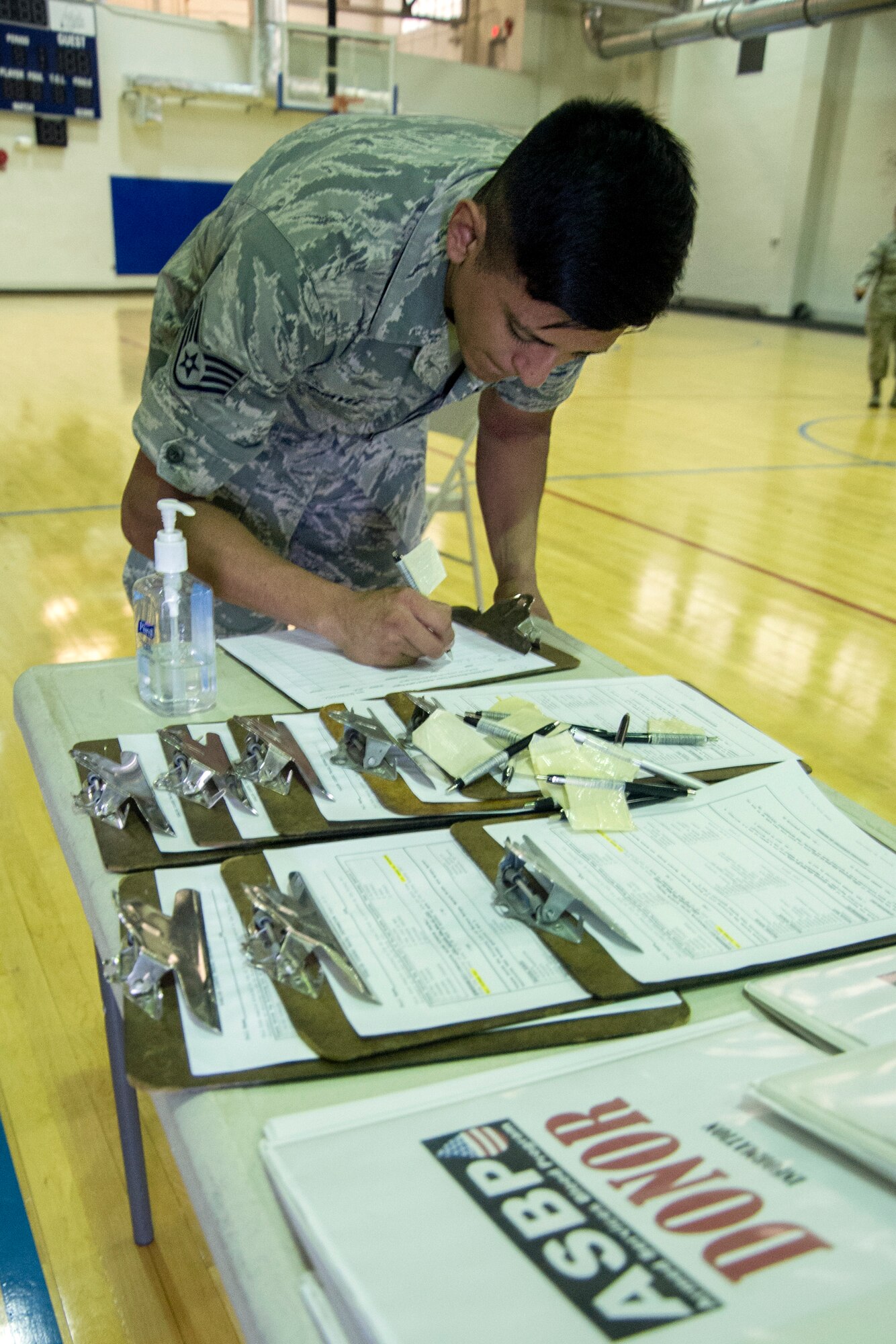 Staff Sgt. Oscar Chavez, 779th Medical Operations Squadron NCO in charge of outreach, signs in to the Armed Services Blood Program blood drive at Joint Base Andrews, Md., June 16, 2016. The 11th Logistics Readiness Squadron, in conjunction with ASBP, collected blood donations that will be shipped into theater and to local medical treatment facilities around the National Capitol Region. (U.S. Air Force photo by Airman Gabrielle Spalding)