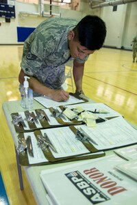 Staff Sgt. Oscar Chavez, 779th Medical Operations Squadron NCO in charge of outreach, signs in to the Armed Services Blood Program blood drive at Joint Base Andrews, Md., June 16, 2016. The 11th Logistics Readiness Squadron, in conjunction with ASBP, collected blood donations that will be shipped into theater and to local medical treatment facilities around the National Capitol Region. (U.S. Air Force photo by Airman Gabrielle Spalding)