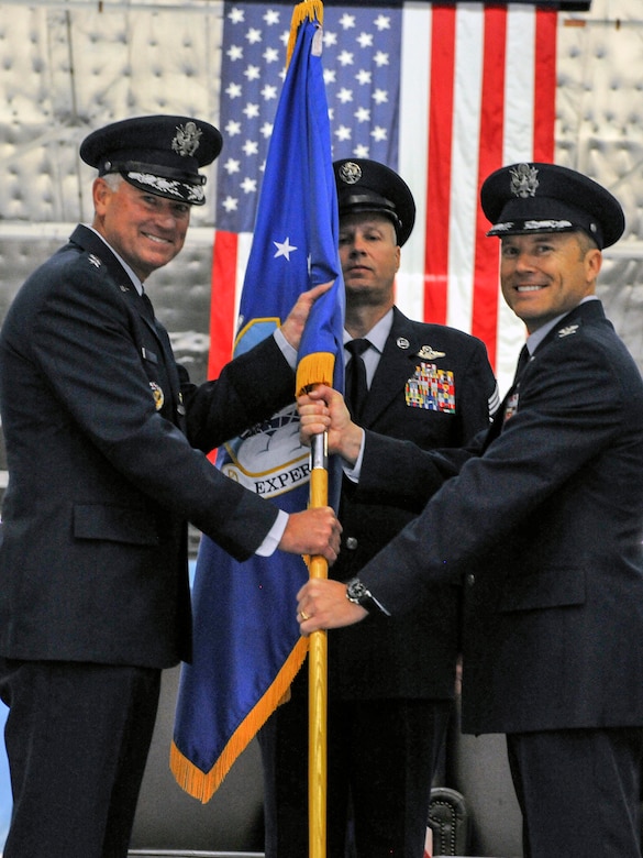 Lt. Gen. Samuel D. Cox, 18th Air Force commander, passes the 89th Airlift Wing guideon to Col. Casey D. Eaton, signifying Eaton’s assumption of command at Joint Base Andrews, Md., June 17, 2016 Eaton assumed command from Col. John C. Millard after serving as the commander of the 515th Air Mobility Operations Wing at Joint Base Pearl Harbor-Hickam, Hawaii. (U.S. Air Force photo by Senior Master Sgt. Kevin Wallace)