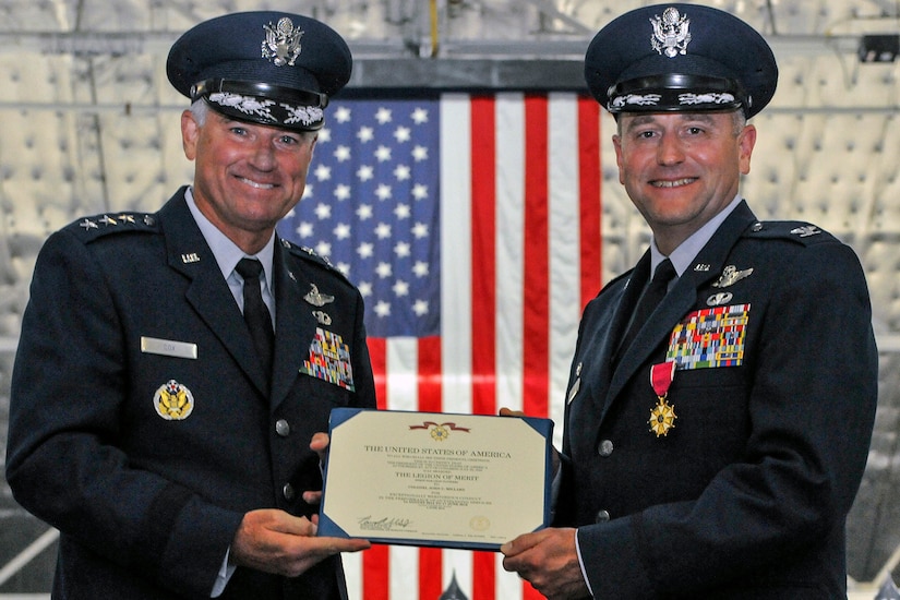 Lt. Gen. Samuel D. Cox, 18th Air Force commander, presents Col. John C. Millard, 89th Airlift Wing commander, with a Legion of Merit medal, during a change-of-command ceremony at Joint Base Andrews, Md., June 17, 2016, at which Millard relinquished command to Col. Casey D. Eaton. The 89th AW is a combat-ready wing of more than 1,100 Airmen and provides Special Airlift Mission airlift and support to the president, vice president, cabinet members, combatant commanders and other senior military and elected leaders, supporting White House, Air Force chief of staff and Air Mobility Command missions. (U.S. Air Force photo by Senior Master Sgt. Kevin Wallace)