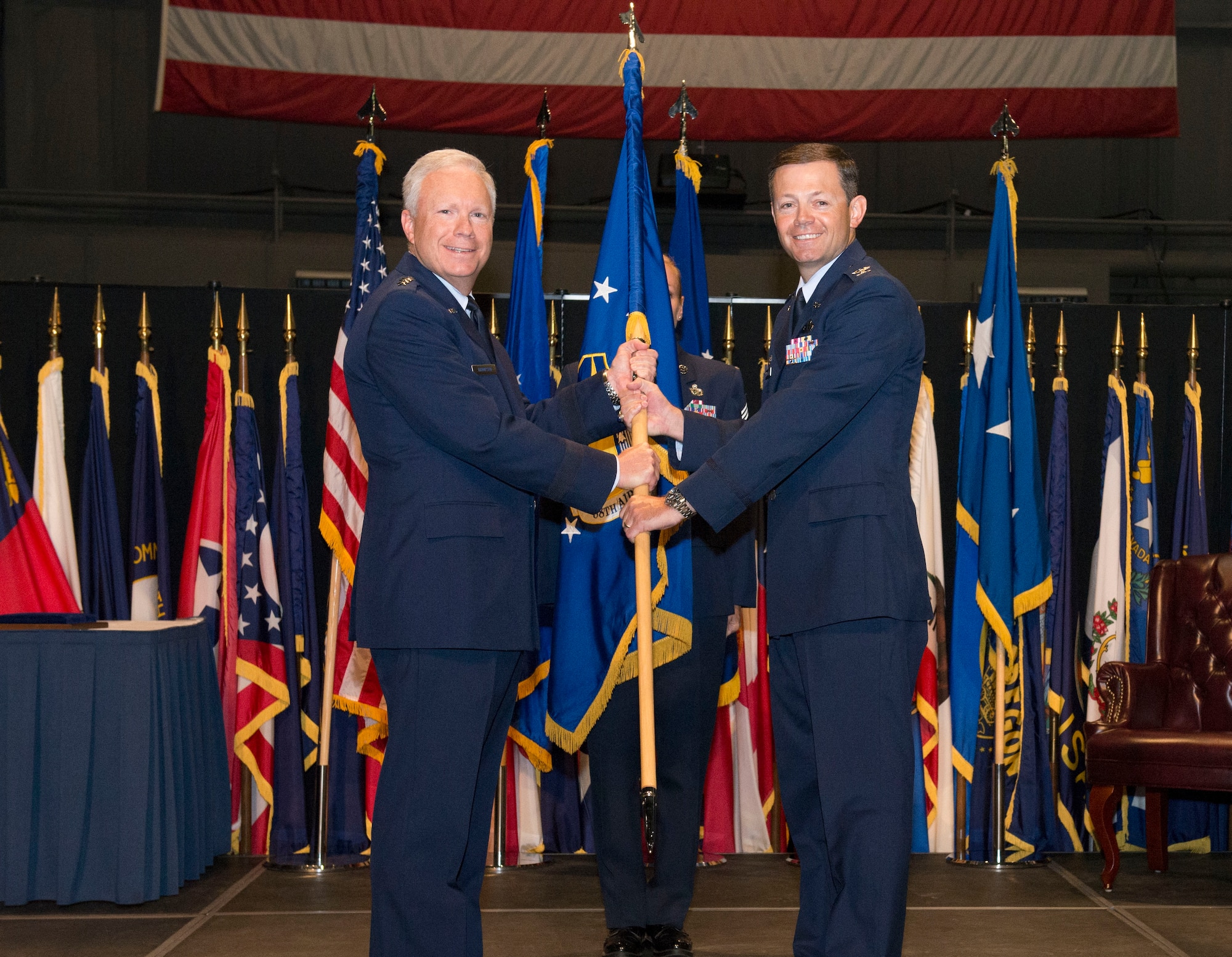 Lt. Gen. John F. Thompson, Air Force Life Cycle Management Center commander, passes the 88th Air Base Wing flag to Col. Bradley McDonald as he assumes command of the Wing during the change of command ceremony on June 21, 2016. (U.S. Air Force Photo / Michelle Gigante)