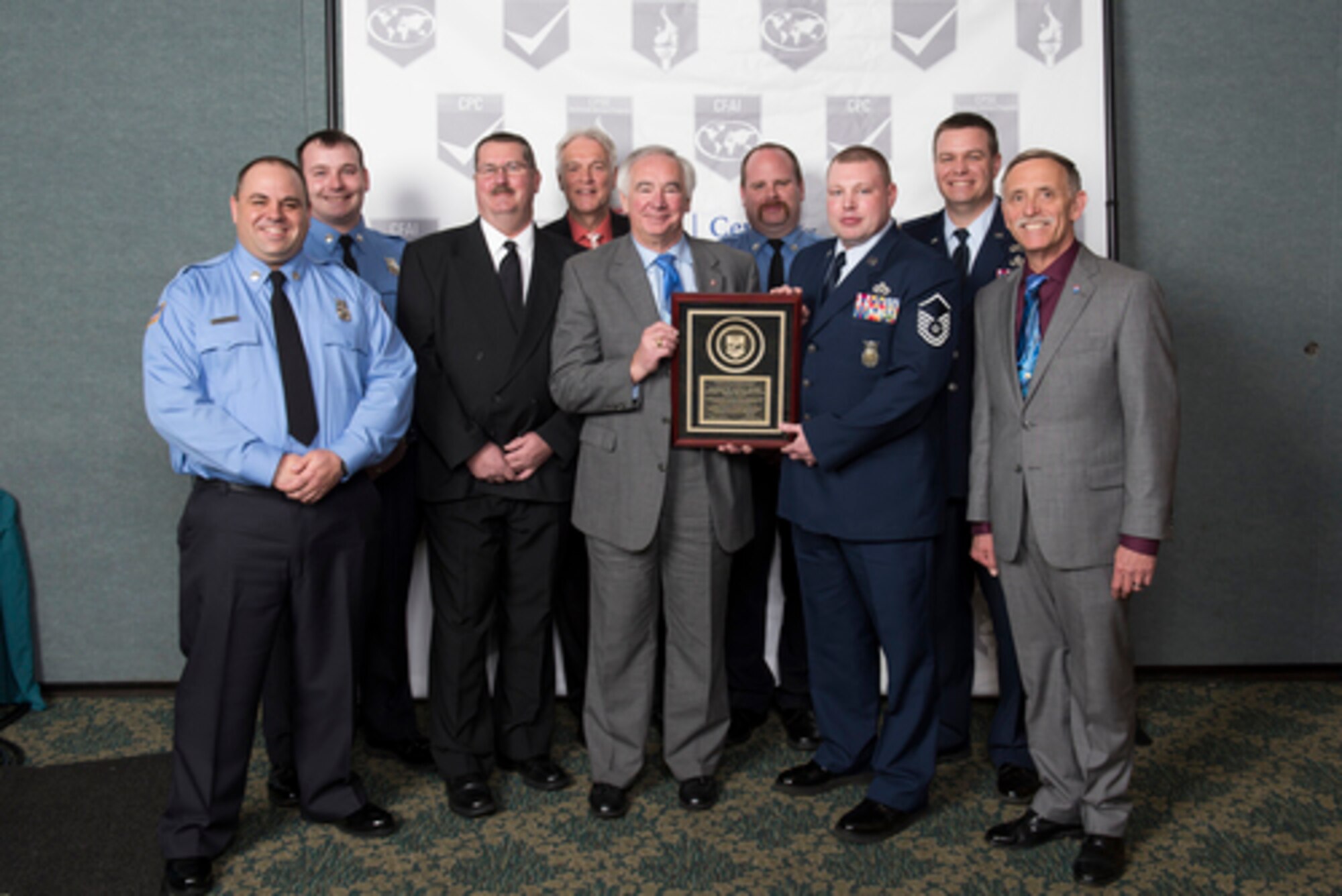 The 115th Fighter Wing Truax Fire and Emergency Services fire department from Madison, Wis., poses with an accreditation plaque in Orlando, Flo., March 16, 2016. The 115 FW Truax Fire and Emergency Services fire department became the first in Dane County and the ninth in the state to be accredited. (Photo courtesy of Master Sgt. Gary Peck)