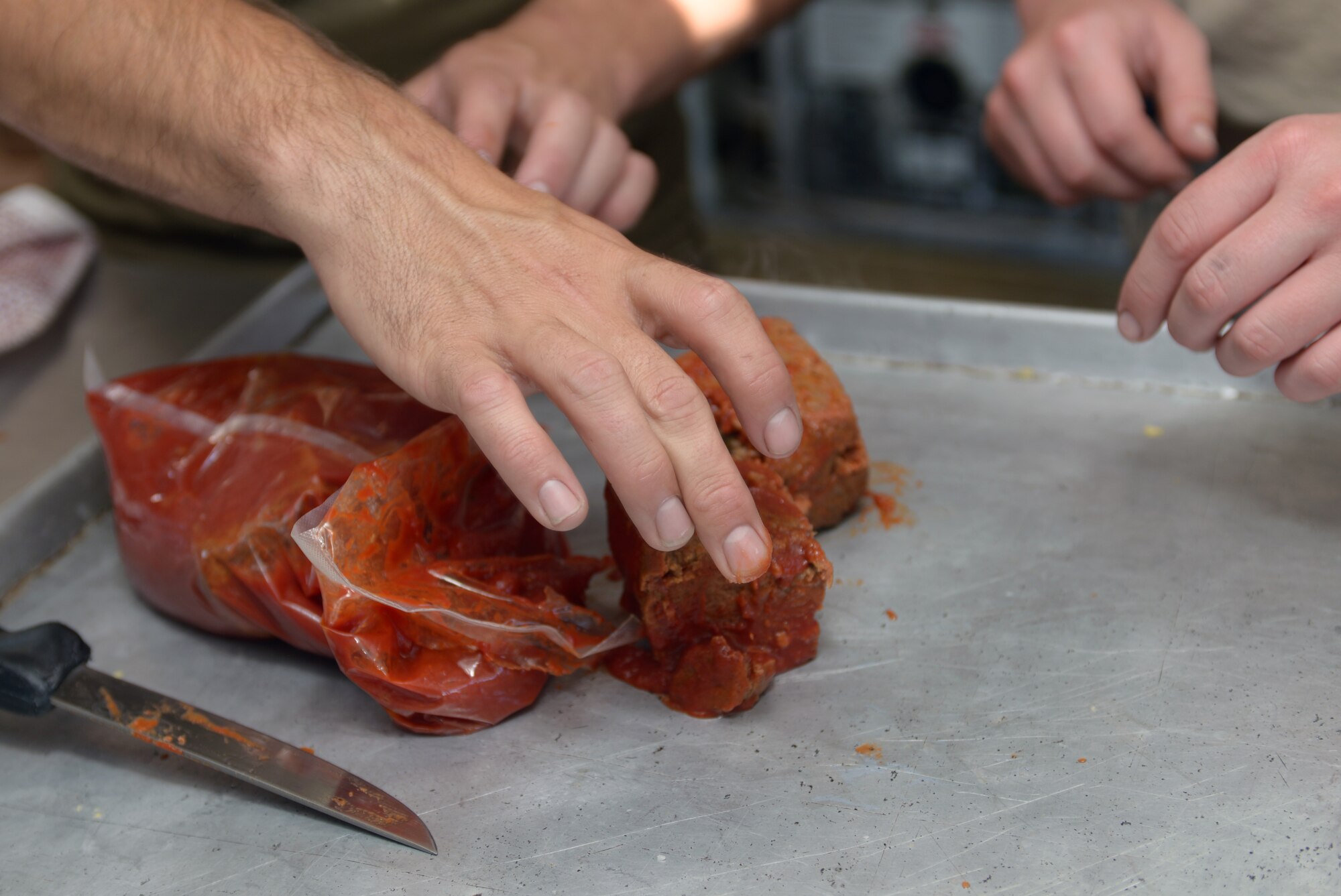 Food service specialists inspect food during the 2016 Golden Coyote exercise at Ellsworth Air Force Base, S.D., June 15, 2016. Food services soldiers stationed at Camp Lancer on EAFB served meals daily to more than 300 servicemembers throughout June in support of the exercise. (U.S. Air Force photo by Airman Donald Knechtel/Released)