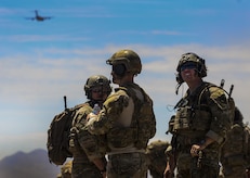 Multiple Joint Terminal Attack Controllers and Combat Controllers watch C-130s fly in formation during the Joint Forcible Entry Exercise portion of the United States Air Force Weapons School Advanced Integration, June 16, 2016. Joint service exercises like the JFEX are integral to maintaining operational cohesiveness between the Air Force and the Army. (U.S. Air Force photo by Airman 1st Class Kevin Tanenbaum)