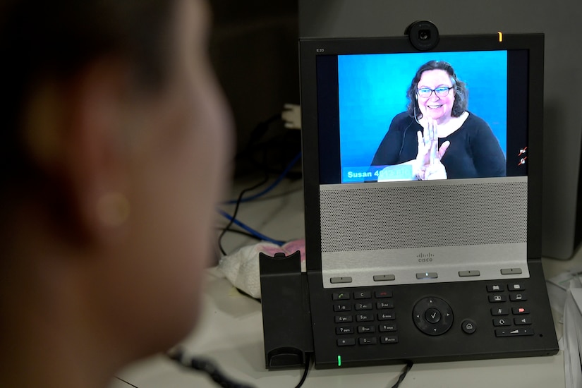 PETERSON AIR FORCE BASE, Colo. – An American Sign Language interpreter helps Rachael McAnallen, 21st Civil Engineer Squadron environmental program manager, by signing what the caller says to her using a videophone at her office June 17, 2016. McAnallen was born deaf, but she learned cued speech, received a cochlear implant and uses innovative technology to enhance communication with others. (U.S. Air Force photo by Senior Airman Rose Gudex)