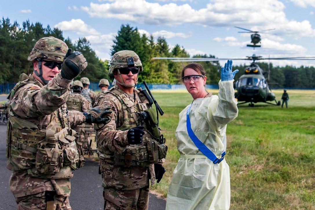 Soldiers direct teams to move toward incoming medical helicopters during a mass casualty exercise as part of Anakonda 2016 in Miloslawiec, Poland, June 11, 2016. Army photo by Sgt. 1st Class John Fries