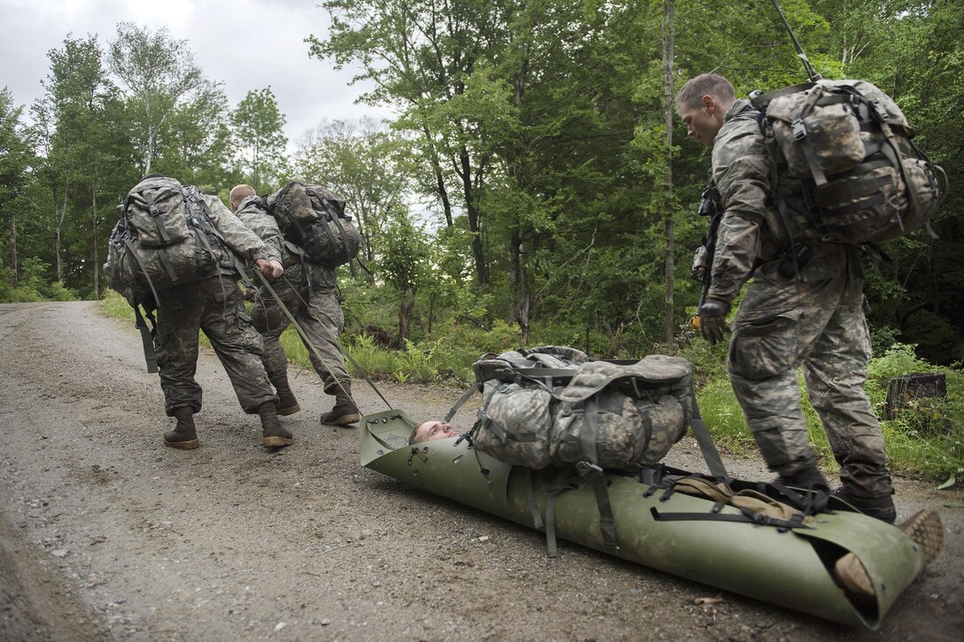 Soldiers drag a simulated wounded patient in an evacuation stretcher while participating in an exercise to assess and evacuate casualties at Camp Ethan Allen Training Site in Jericho, Vt., June 12, 2016. Air National Guard photo by Tech. Sgt. Sarah Mattison