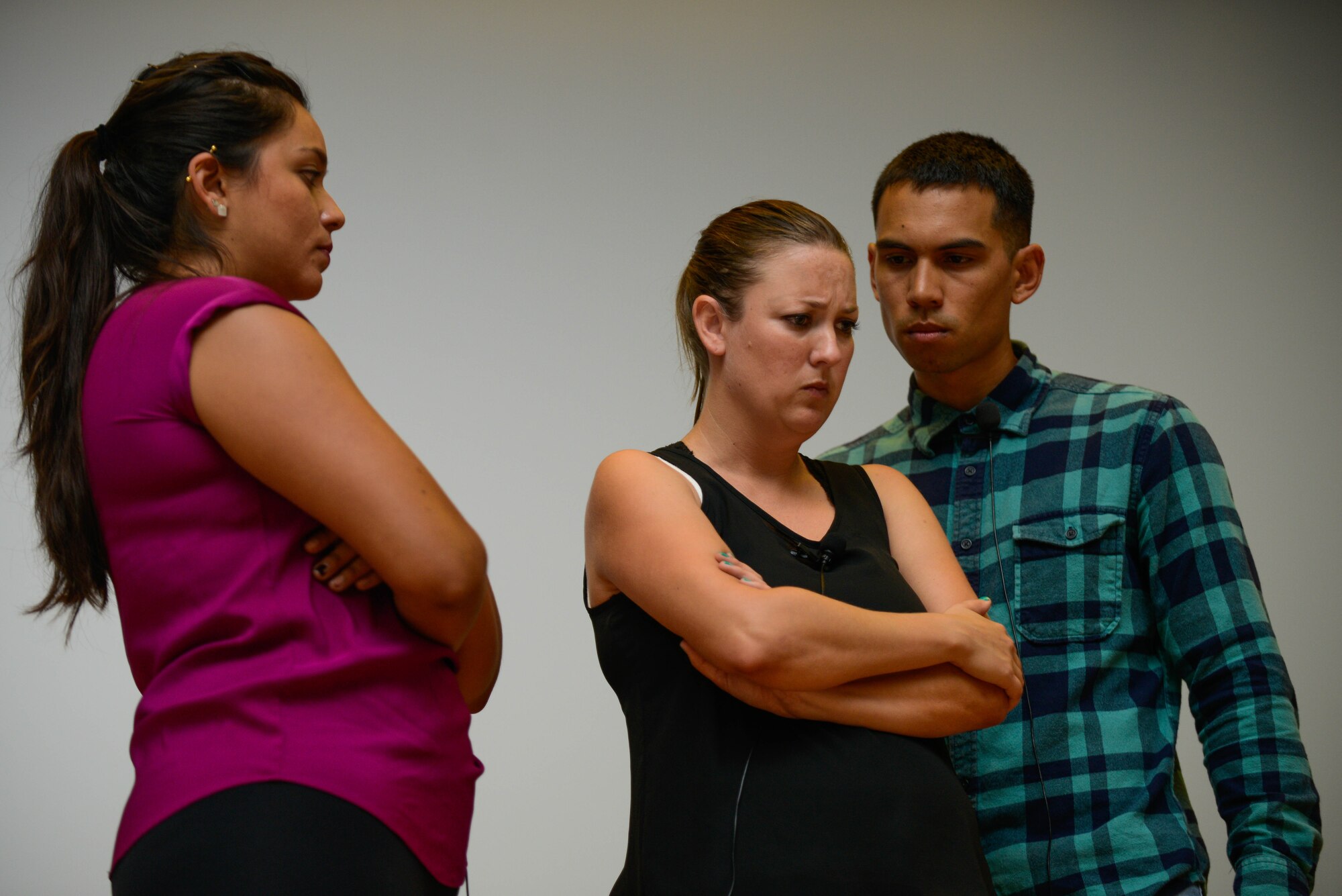 Actors from the Pure Praxis theater group portray two judgmental friends around a sexual assault victim during a bystander intervention play at Osan Air Base, Republic of Korea.  The theater group used improvisational theater to create realistic bystander intervention situations so audience members could rehearse proactive responses. (U.S. Air Force photo by Senior Airman Dillian Bamman/Released)