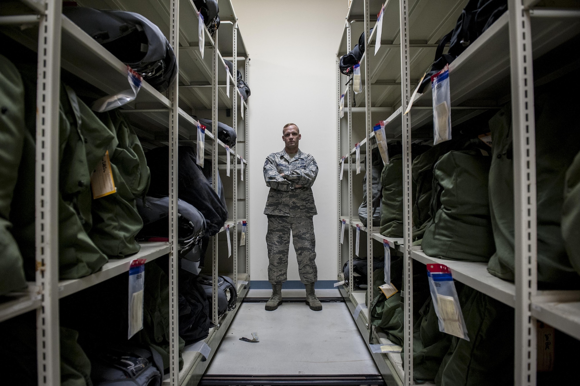 U.S. Air Force Tech. Sgt. Matthew Michels is a 31st Rescue Squadron aircrew flight equipment assistant NCO in charge at Kadena Air Base, Japan. Michels ensures the safety aircrews jumping from aircraft by packing and maintaining parachute packs and a variety of equipment including oxygen bottles, masks, life preservers, altimeters and night vision goggles. (U.S. Air Force photo by Senior Airman Peter Reft)