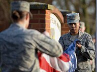 U.S. Air Force Senior Airman Tynisha Spencer, 100th Logistics Readiness Squadron traffic management journeyman, prepares the U.S. flag during a retreat ceremony March 25, 2016, on RAF Mildenhall, England. Spencer has been a member of the base honor guard team since 2014 and has completed more than 250 hours to the program. (U.S. Air Force photo by Senior Airman Victoria Taylor/Released)