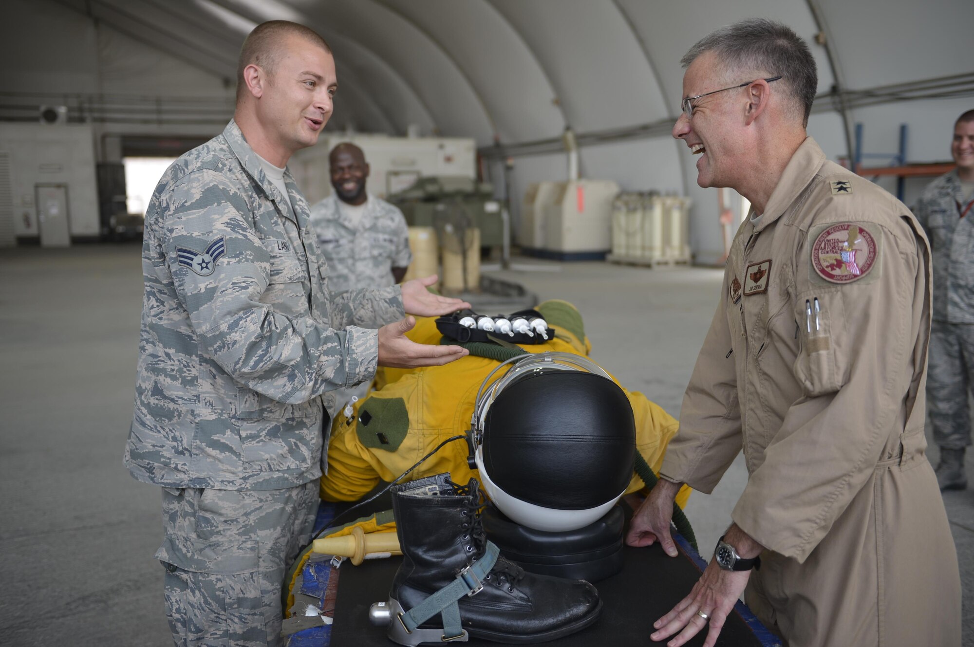 Senior Airman Kyle, 99th Expeditionary Reconnaissance Squadron, explains the intricacies of the suit worn by U-2 Dragon Lady pilots to Maj. Gen. Jay Silveria, Deputy Commander, Combined Air Force Air Component, U.S. Central Command, June 18. This discussion was one of several Maj. Gen. Silveria had with U.S. and Coalition service members during his visit with the 380th Air Expeditionary Wing at an undisclosed location in Southwest Asia. (U.S. Air Force photo by Tech. Sgt. Chad Warren)