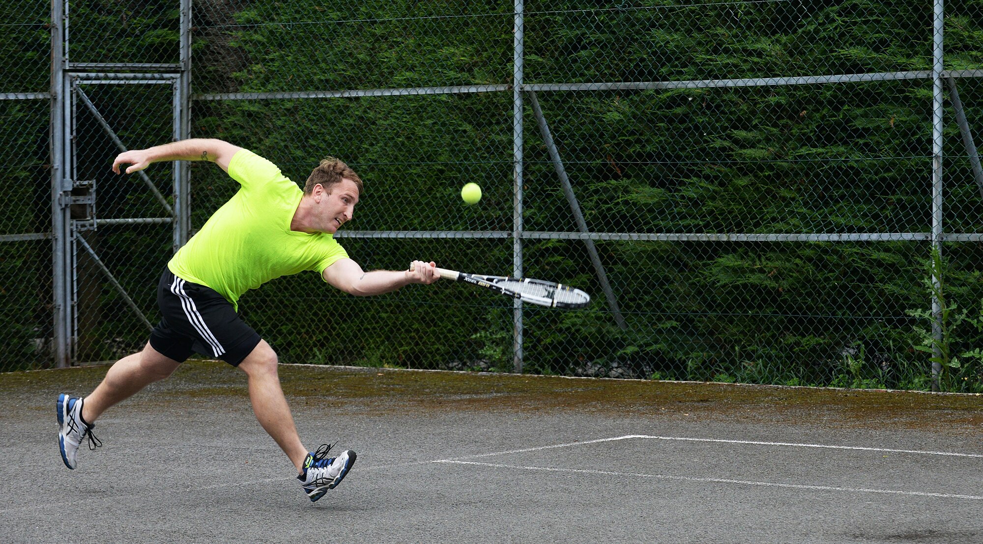 U.S. Air Force Staff Sgt. Brad Coats, 488th Intelligence Squadron mission support supervisor, competes in a singles tennis match during the Marauder Melee event June 16, 2016, on RAF Mildenhall, England. The event was open to all base ID card holders and included various sports such as basketball, table tennis, dodge ball, tennis and more. (U.S. Air Force photo by Airman 1st Class Tenley Long/Released)