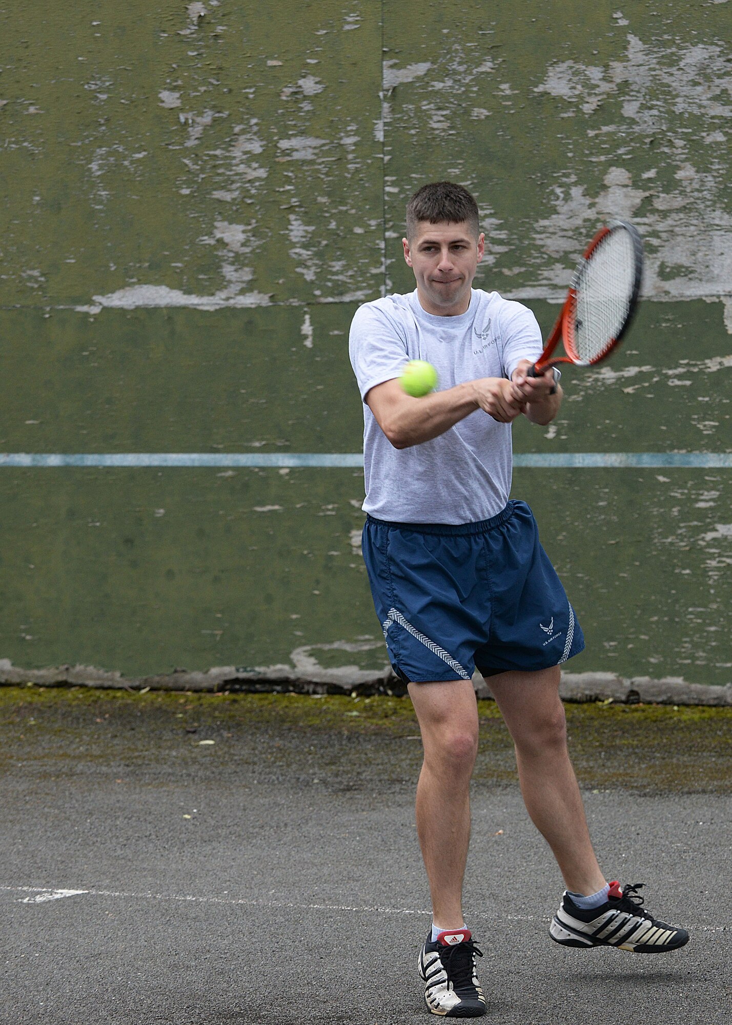 U.S. Air Force Staff Sgt. Joshua Johnson, 100th Operations Support Squadron Airfield Management Operations supervisor, participates in a singles tennis match during the Marauder Melee event June 16, 2016, on RAF Mildenhall, England. Marauder Melee was a sports competition between squadrons throughout the installation. (U.S. Air Force photo by Airman 1st Class Tenley Long/Released)