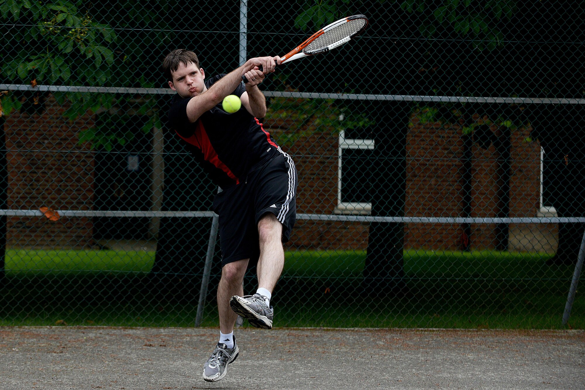 U.S. Air Force Tech. Sgt. Kyle Amburn, 488th Intelligence Squadron NCO in charge of quality assurance, engages in a singles tennis match during the Marauder Melee event June 16, 2016, on RAF Mildenhall, England. Marauder Melee is a sports competition between squadrons throughout the installation. (U.S. Air Force photo by Airman 1st Class Tenley Long/Released)
