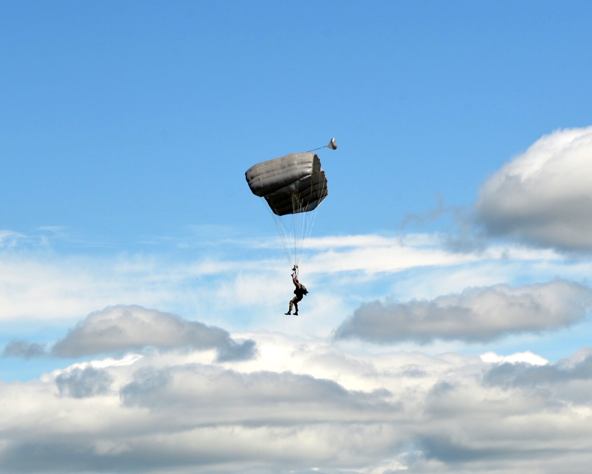 Senior Airman Mitchell Jacobs, 103rd Rescue Squadron pararescue jumper, parachutes into the drop zone during a pararescue training jump at Amari Air Base, June 12, 2016 at Amari Air Base, Estonia as part of Saber Strike 16. Saber Strike is a multinational exercise that tests the capabilities of various aspects of the militaries involved. (U.S. Air National Guard photo/Staff Sgt. Blake Mize/released)