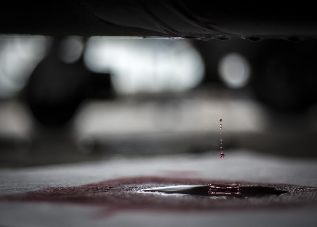 Hydraulic fluid leaks from a tow bar being serviced June 20, 2016, at Aviano Air Base, Italy. The 31st Maintenance Squadron aerospace ground equipment flight services, inspects, troubleshoots, repairs and performs maintenance on generators, air conditioners, hydraulic test stands, munitions lifts and other equipment. (U.S. Air Force photo by Airman 1st Class Cory W. Bush/Released)