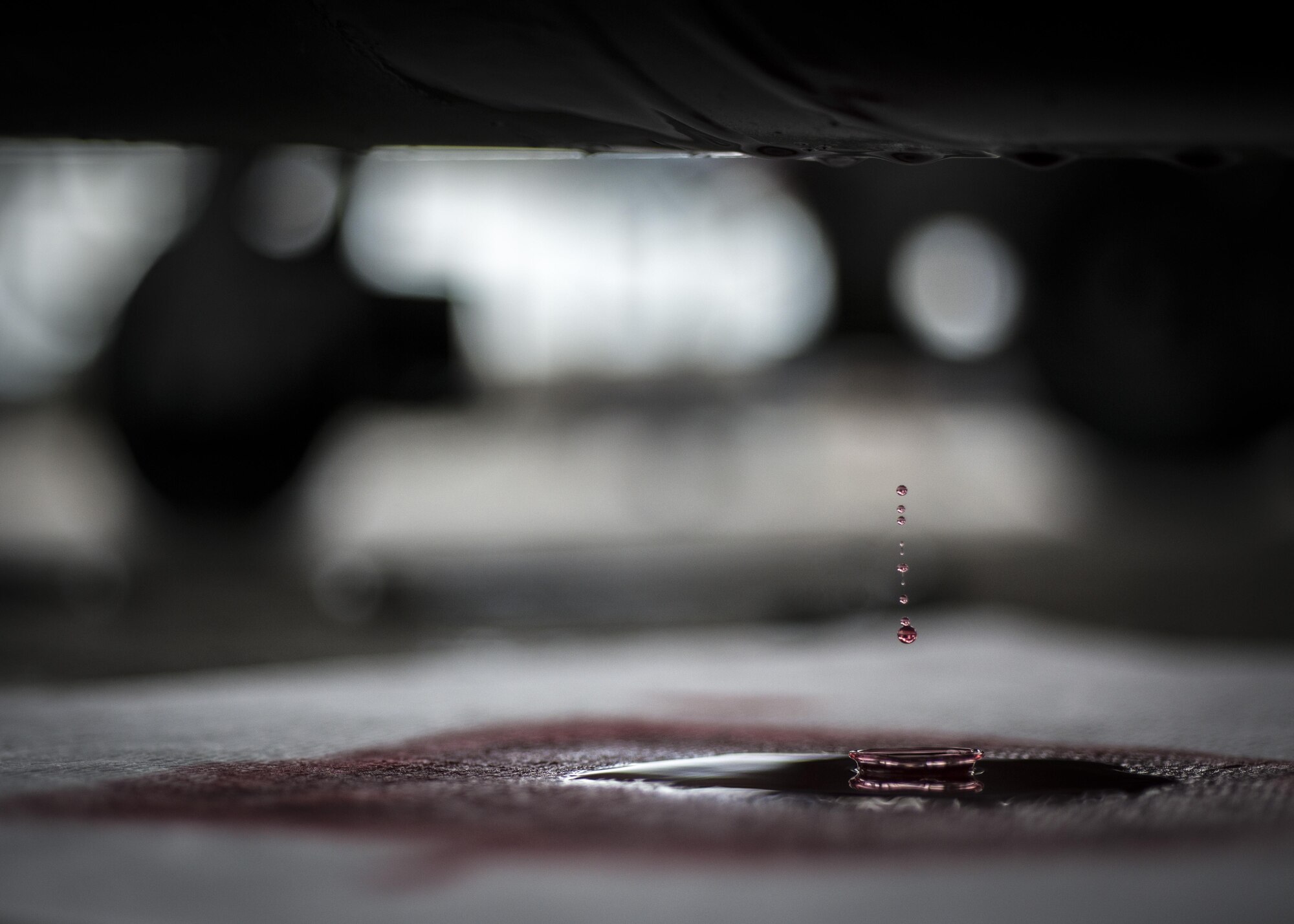 Hydraulic fluid leaks from a tow bar being serviced June 20, 2016, at Aviano Air Base, Italy. The 31st Maintenance Squadron aerospace ground equipment flight services, inspects, troubleshoots, repairs and performs maintenance on generators, air conditioners, hydraulic test stands, munitions lifts and other equipment. (U.S. Air Force photo by Airman 1st Class Cory W. Bush/Released)