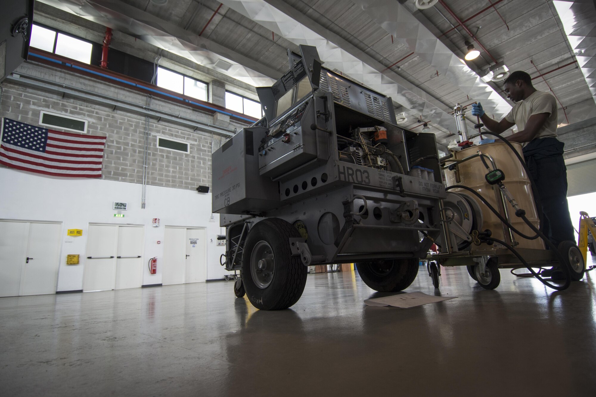 Airman Kwabena Prempeh, 31st Maintenance Squadron aerospace ground equipment apprentice, replaces engine oil on a portable heater unit June 20, 2016, at Aviano Air Base, Italy. The 31st MXS AGE Airmen service, inspect, troubleshoot, repair and perform maintenance on generators, air conditioners, hydraulic test stands, munitions lifts and other equipment. (U.S. Air Force photo by Airman 1st Class Cory W. Bush/Released)