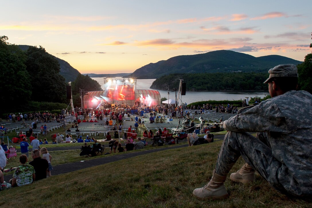 A soldier watches the Lt. Dan Band perform at Trophy Point overlooking the Hudson River during the closing ceremony for the 2016 Department of Defense Warrior Games at the U.S. Military Academy in West Point, N.Y., June 21, 2016. DoD photo by EJ Hersom