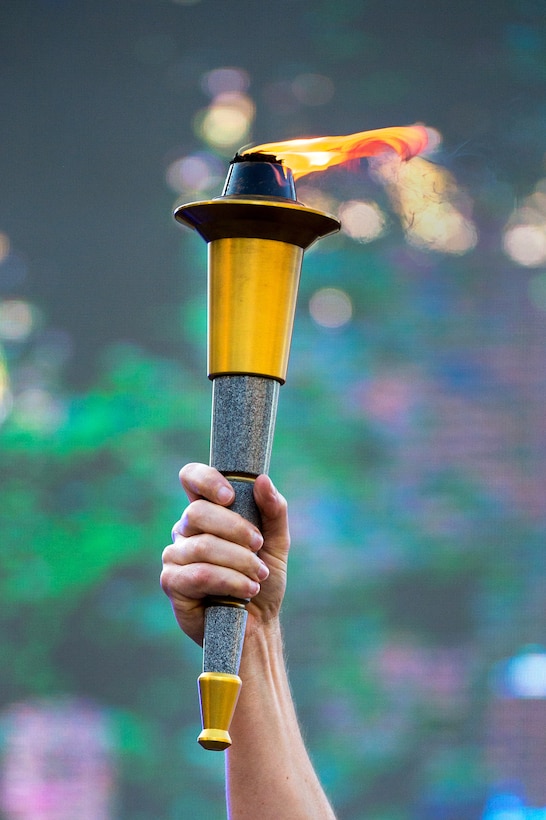 Navy Vice Admiral Dixon Smith, commander of Navy Installations Command, holds the Warrior Games torch during the closing ceremony for the games at the U.S. Military Academy in West Point, N.Y., June 21, 2016. DoD photo by EJ Hersom