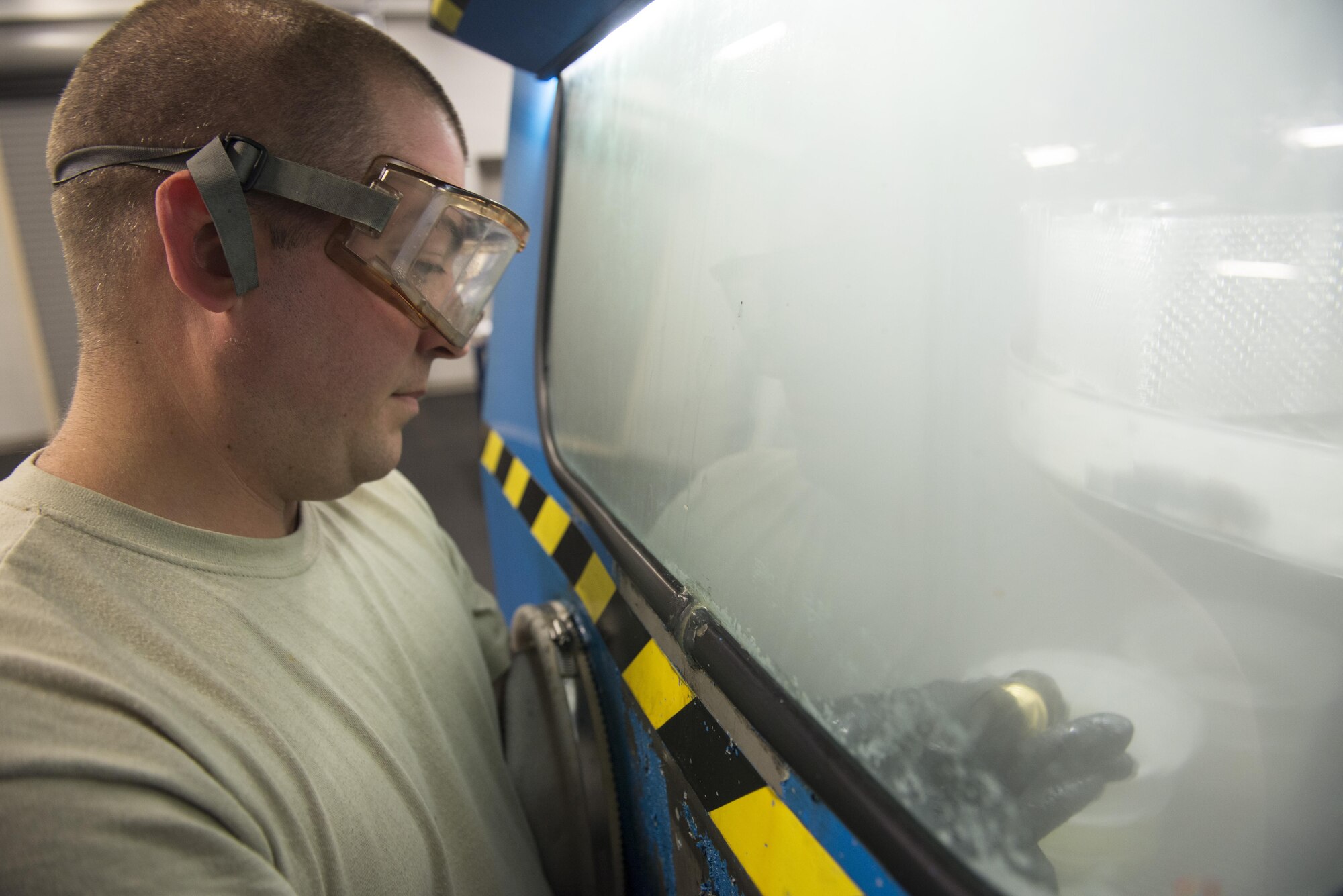 Staff Sgt. Mark Gower, 33rd Maintenance Squadron wheel and tire technician, washes F-35 wheel parts in a parts washer June 9, 2016, at Eglin Air Force Base, Fla. Members of the 33rd MXS Wheel and Tire Shop use the parts washer to clean break dust and old grease off of wheel assemblies to prepare them for a new tire and wheel bearing, ensuring proper tire function. (U.S. Air Force photo by Senior Airman Stormy Archer/Released)