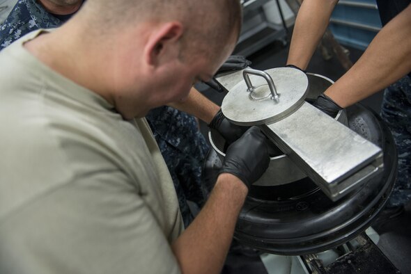 Members of the 33rd Maintenance Squadron assemble an F-35 tire June 9, 2016, at Eglin Air Force Base, Fla. The F-35 Wheel and Tire Shop at Eglin AFB is the only wheel and tire shop in the F-35 program that is integrated with both Air Force and Navy personnel. The 33rd MXS Wheel and Tire Shop builds an average of 50 a month for F-35s stationed at Eglin AFB. (U.S. Air Force photo by Senior Airman Stormy Archer/Released)