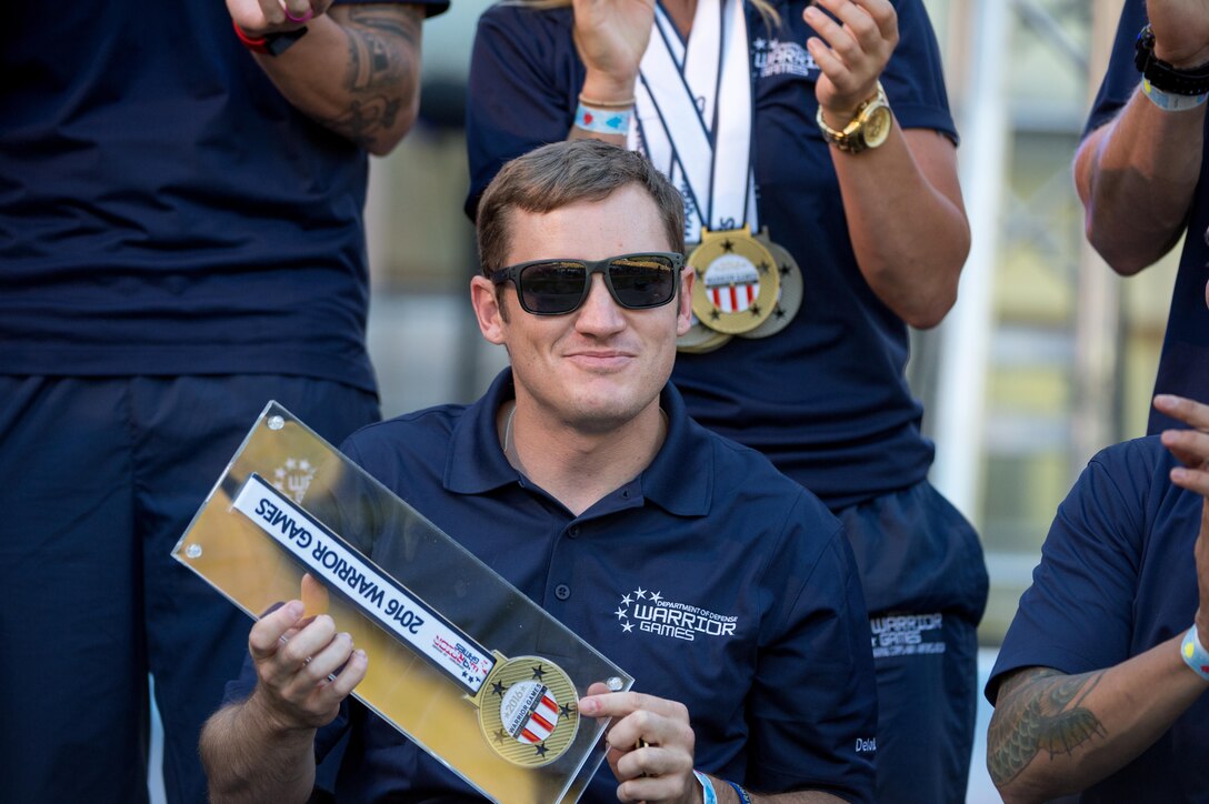 Navy veteran Austin Field holds his Heart of the Team Award for the Navy team during the closing ceremony for the 2016 Department of Defense Warrior Games at the U.S. Military Academy in West Point, N.Y., June 21, 2016. DoD photo by EJ Hersom