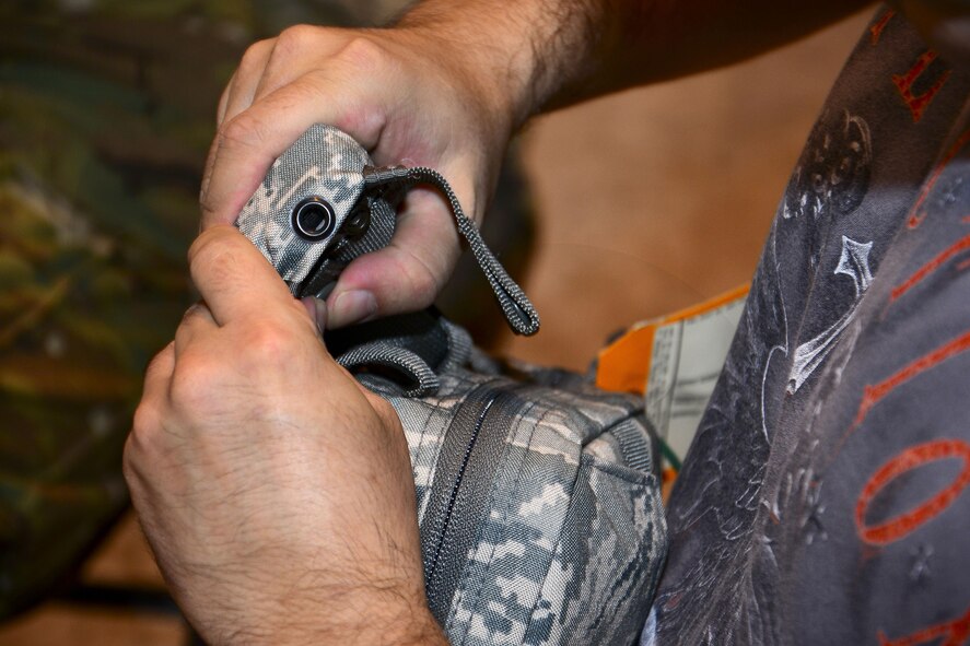 U.S. Air Force Staff Sgt. Michael Sanchez, 379th Operation Silent Sentry space systems operator, puts together a joint first aid kit (JFAK) at Al Udeid Air Base, Qatar, June 15, 2016. The JFAK is an upgraded version of the previous individual first aid kit. The JFAK ensures all service members use a common first aid kit while serving down-range. (U.S. Air Force photo by Senior Airman Kimberly Nagle)