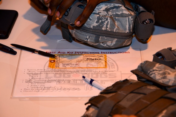 Directions on how to properly inspect and put together a joint first aid kit (JFAK) sits on a table at Al Udeid Air Base, Qatar, June 15, 2016. Each JFAK is hand inspected and signed off by the inspector to ensure each item inside is not expired or close to expiration. (U.S. Air Force photo by Senior Airman Kimberly Nagle)