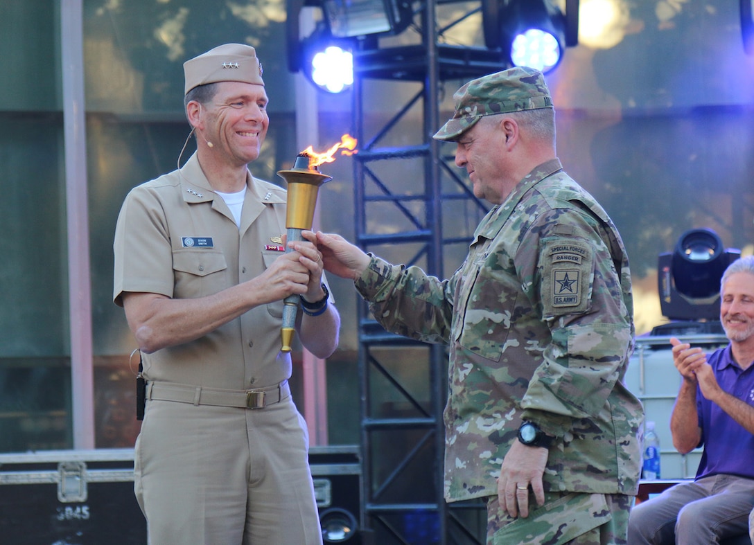 Navy Vice Adm. Dixon R. Smith, commander of Navy Installations Command, receives the DoD Warrior Games torch from Army Chief of Staff Gen. Mark A. Milley at the closing ceremonies for the 2016 Department of Defense Warrior Games at West Point, N.Y., June 21, 2016. The Navy will host the 2017 games next June in Chicago. Army photo by Sgt. Brandon Rizzo