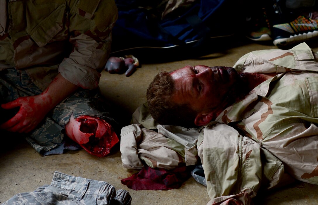 British nationals volunteer as wounded service members during a joint training exercise at Stanford Training Area, England, June 14. Special-Purpose Marine Air-Groud Task Force Crisis Response unit, composed of U.S. Marines and Sailors, along with U.S. Air Force pararescuemen, participated in the exercise to enhance interoperability and to aquire various medical and evacuation techniques through realistic application. (U.S. Air Force photo/Senior Airman Erin Trower) 