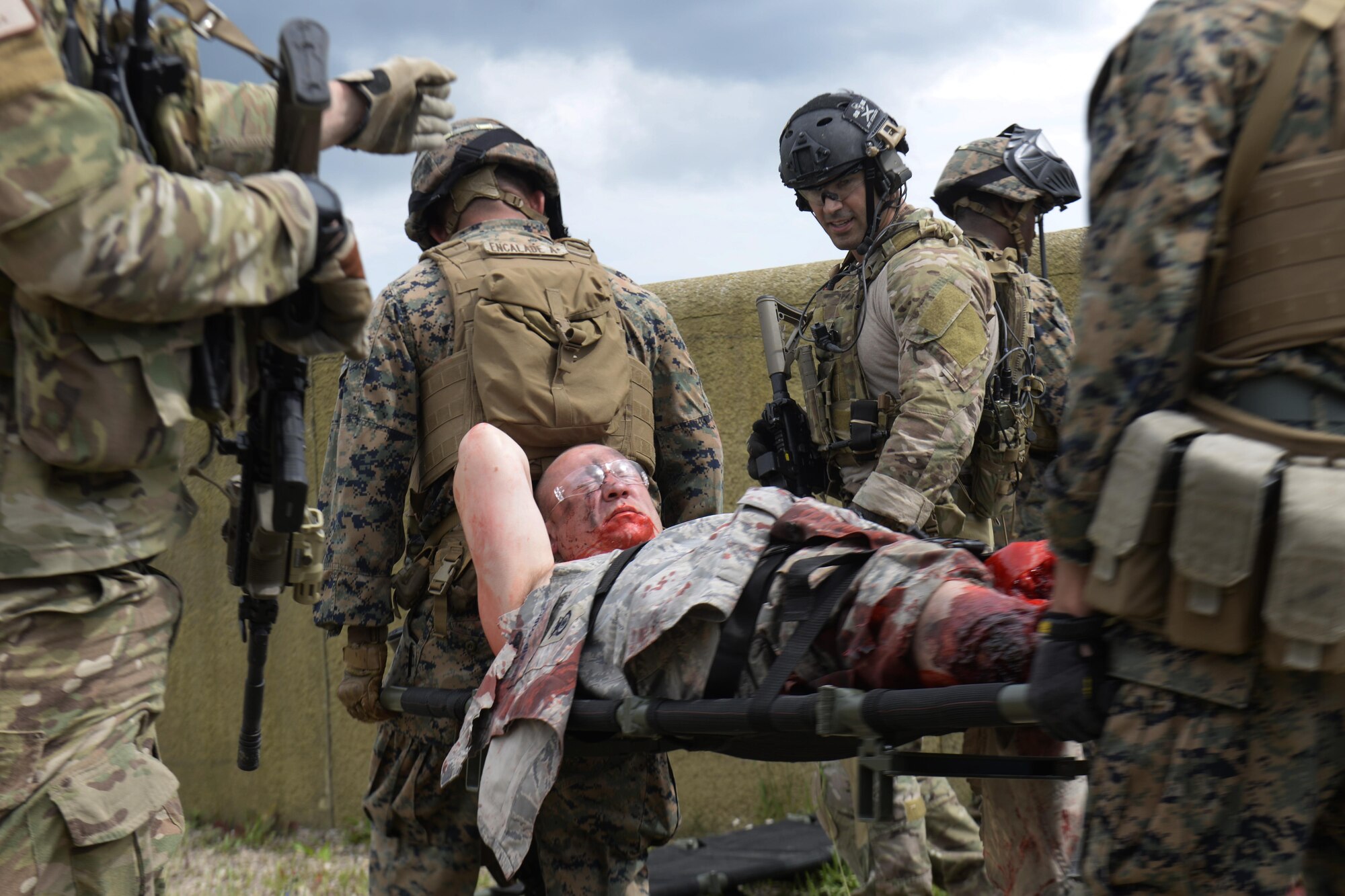U.S. Marines assigned to the Special-Purpose Marine Air-Ground Task Force Crisis Response Africa unit carry a casualty victim on a stretcher during a joint training exercise at Stanford Training Area, England, June 14. British amputees volunteered as wounded service members to add realism to the training scenarios. (U.S. Air Force photo/Airman 1st Class Abby L. Finkel)
