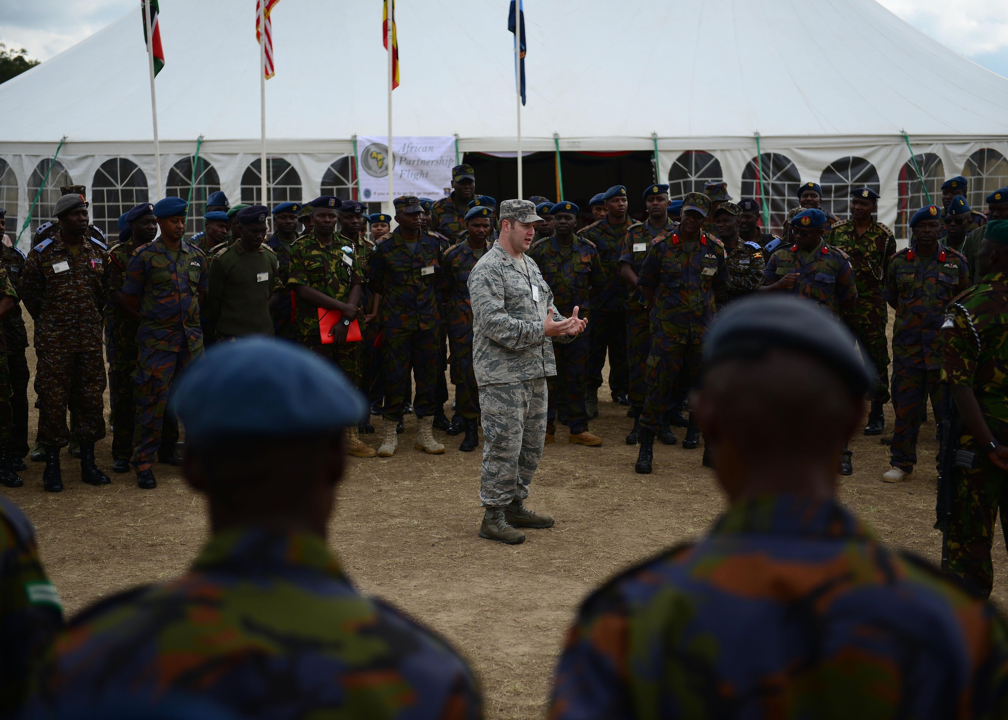 U.S. Air Force Maj. Todd Tyler, U.S. Air Forces in Europe and Air Forces Africa, African Partnership Flight Kenya mission commander, speaks with Kenyan and Ugandan Defense Forces at Laikipia Air Base, Kenya, June 20, 2016. More than 50 U.S. Air Force Airmen participated in the first African Partnership Flight in Kenya. The APF is designed for U.S. and African partner nations to work together in a learning environment to help build expertise and professional knowledge and skills. (U.S. Air Force photo by Tech. Sgt. Evelyn Chavez/Released)