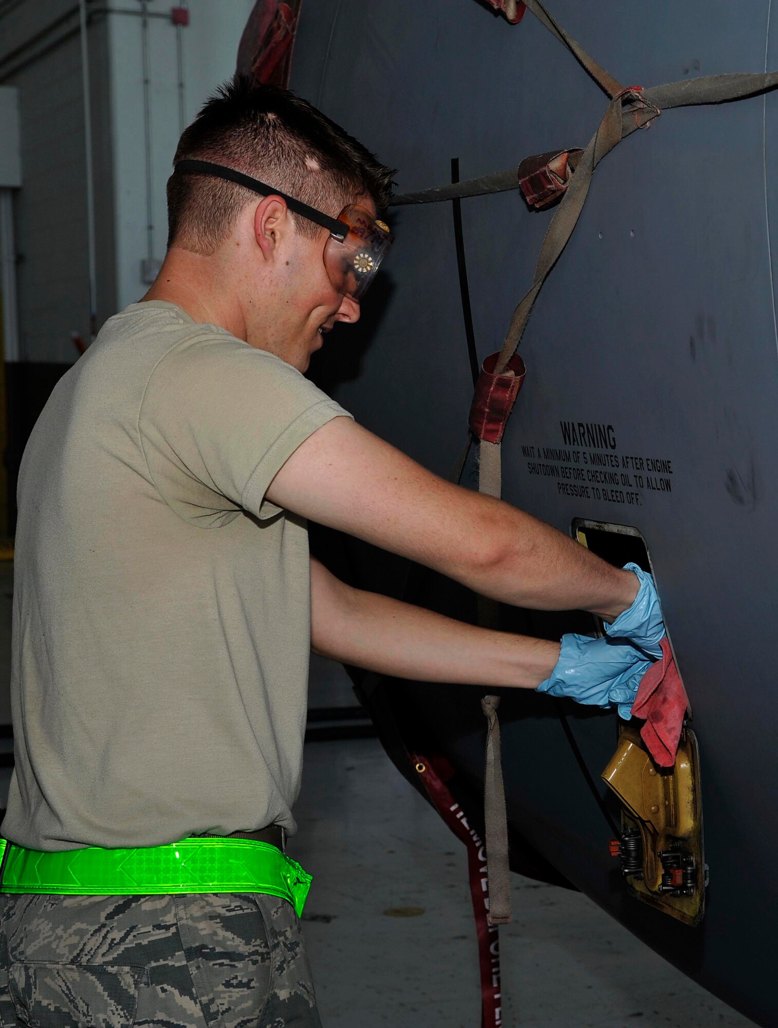 Airman 1st Class Samuel Gebhart, 22nd Aircraft Maintenance Squadron crew chief, simulates checking the engine oil level on a KC-135 Stratotanker for training, June 17, 2016, at McConnell Air Force Base, Kan. Engine oil is checked after every flight to ensure proper quantities are maintained. (U.S. Air Force photos/Airman Erin McClellan)
