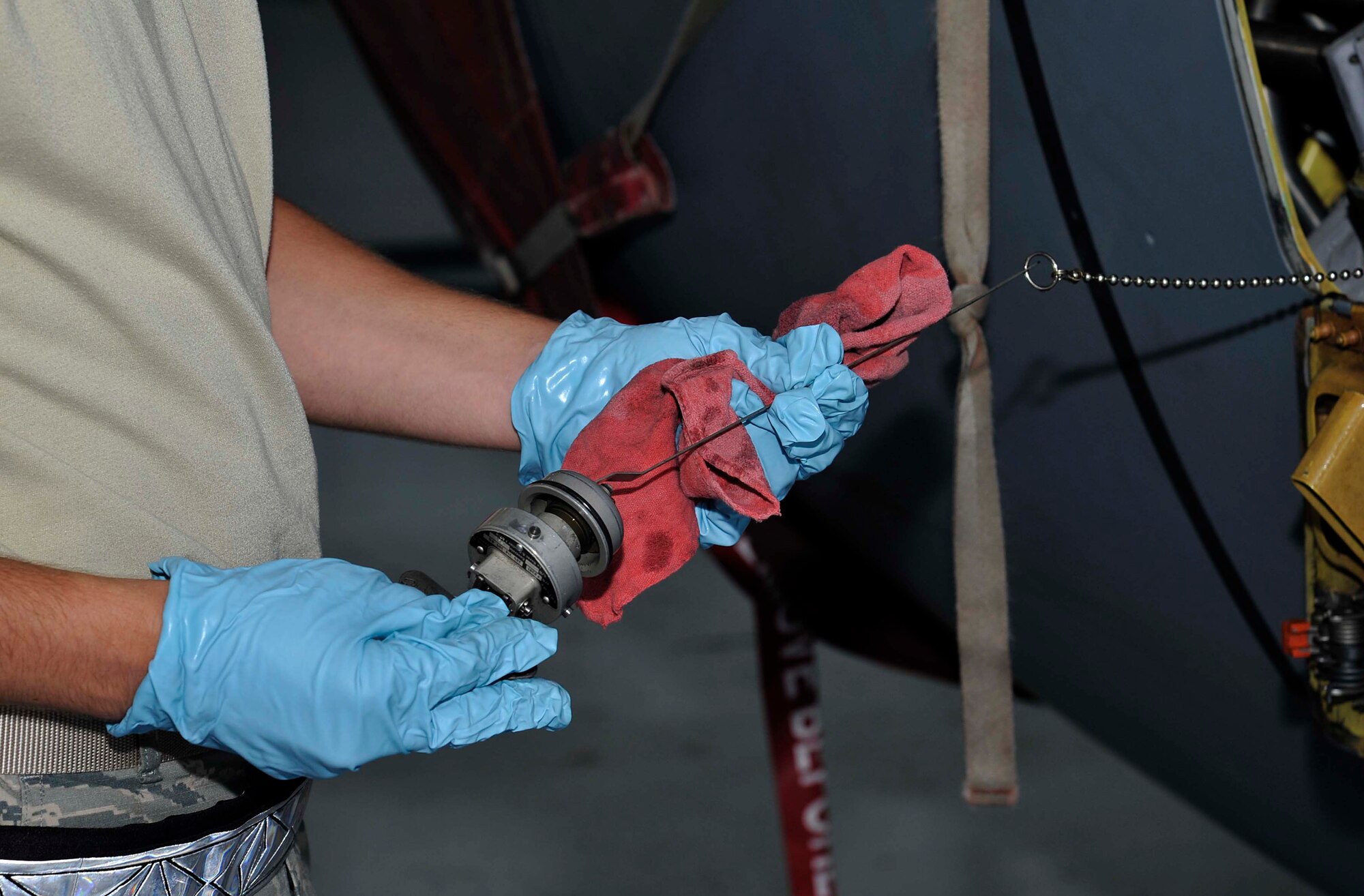 Airman 1st Class Gregory Newsom, 22nd Aircraft Maintenance Squadron crew chief, simulates checking the engine oil level on a KC-135 Stratotanker for training, June 17, 2016, at McConnell Air Force Base, Kan. Engine oil is checked after every flight to ensure proper quantities are maintained. (U.S. Air Force photos/Airman Erin McClellan)
