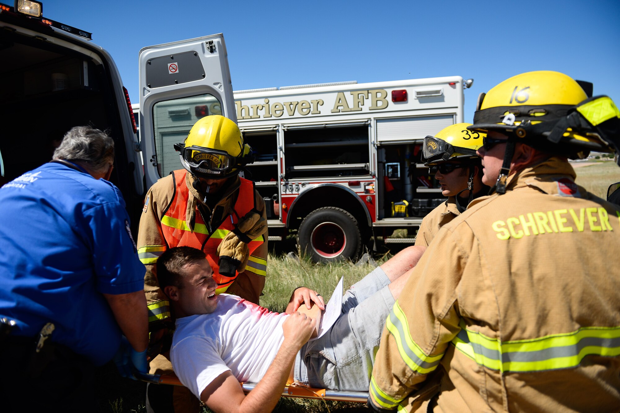 First responders tend to a victim during a base exercise, Opinicus Vista 16-2, at Schriever Air Force Base Colorado, Wednesday, June 15, 2016. Base personnel acted as victims during a tornado scenario. (U.S. Air Force photo/Christopher DeWitt)
